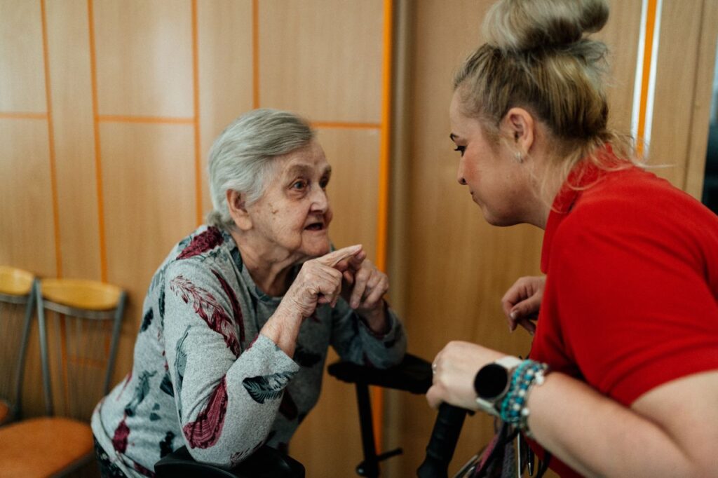 The Art of Drawing Readers In: Your attractive post title goes here Elderly woman and caregiver in conversation inside a room in Karviná, Česko.